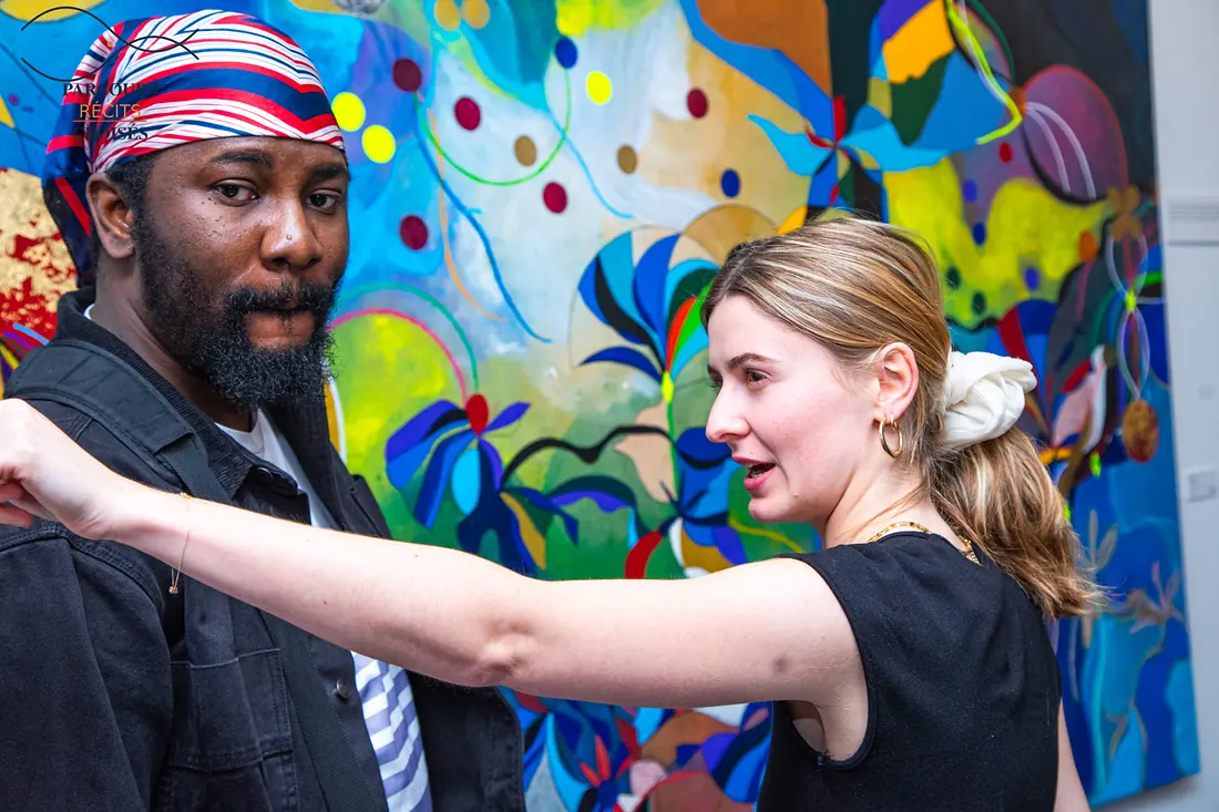 A guest points out a detail in a painting