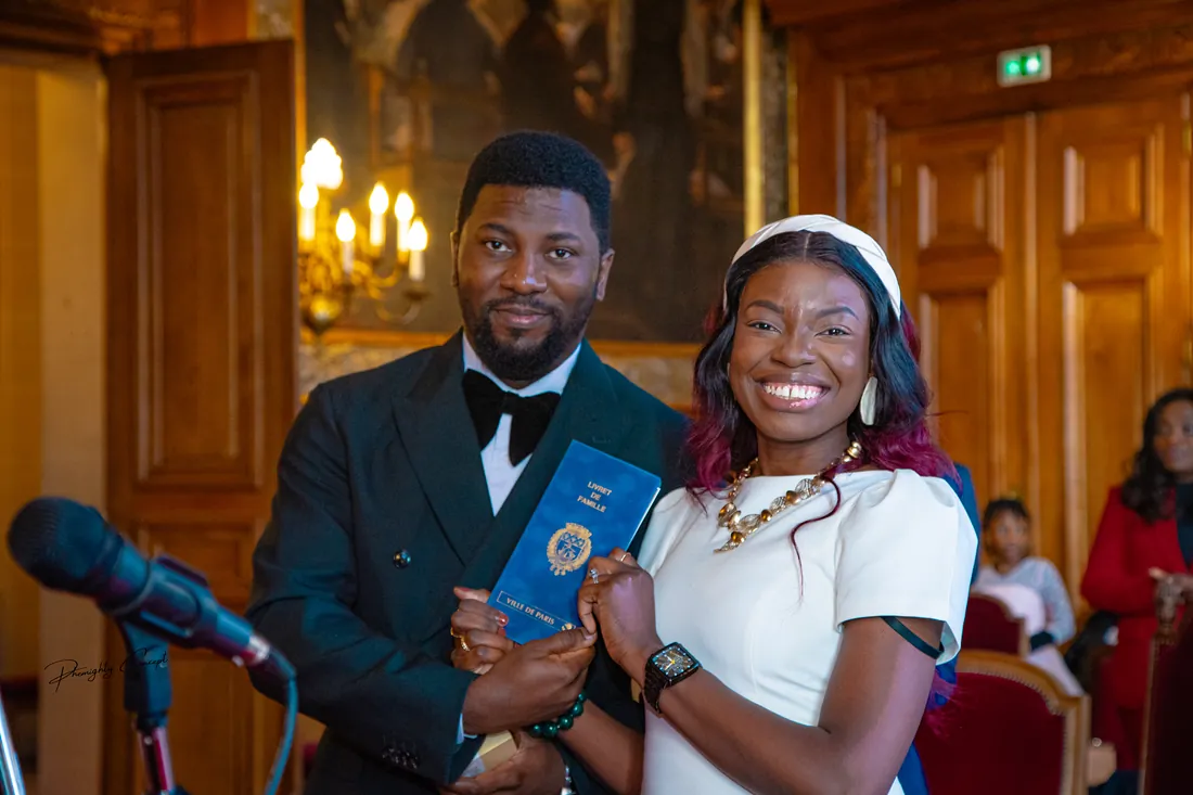 The newlyweds holding their family record book